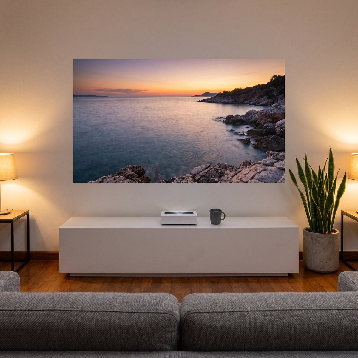 DSX 3 Mini on a white TV console projecting a 100-inch sunset picture onto the wall